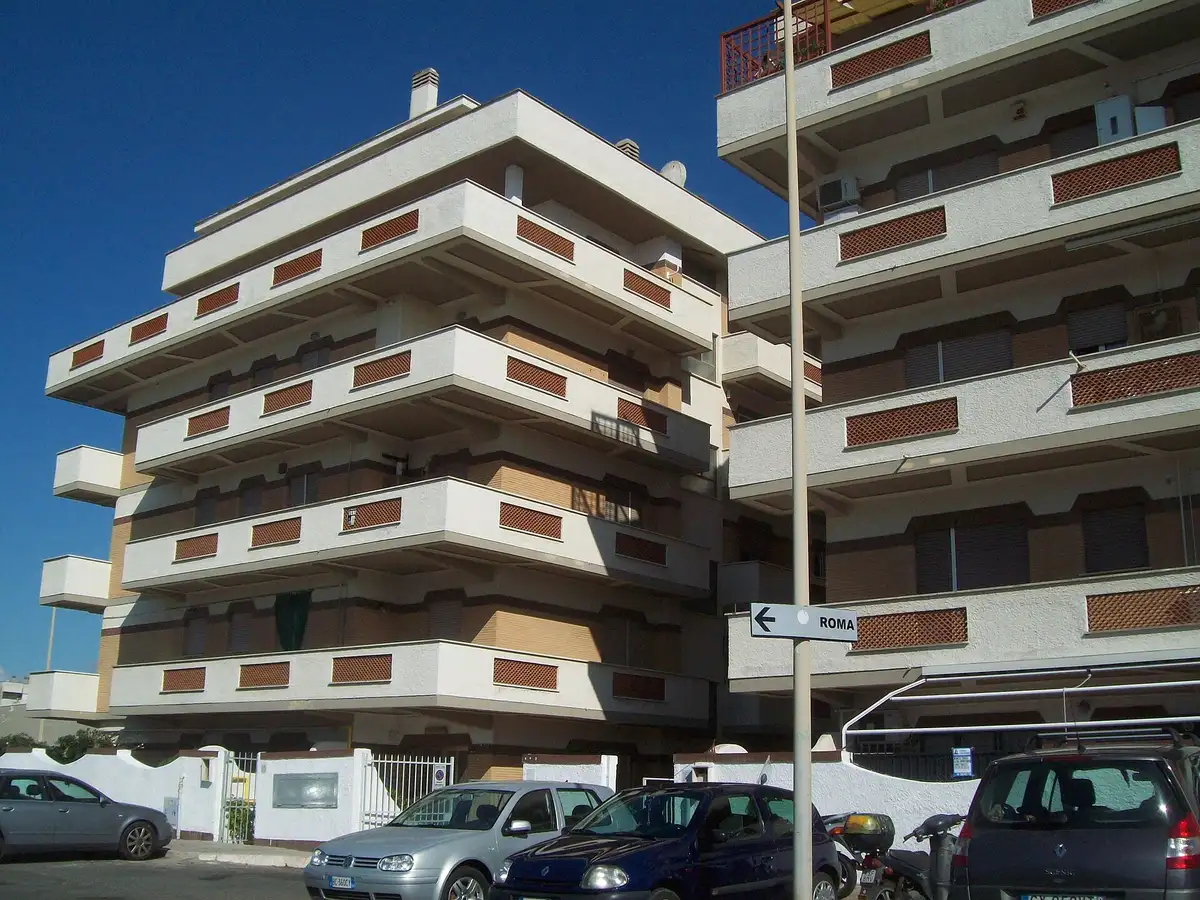 A post-war residential block with stacked balconies near Rome.
